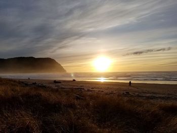 Scenic view of beach against sky during sunset