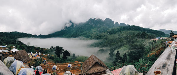 Panoramic view of trees and buildings against sky