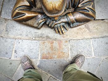 Low section of person standing on tiled floor