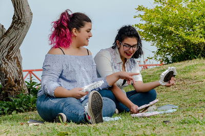 Women sitting on a young woman looking at camera