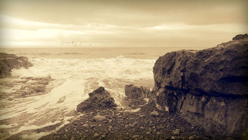 Scenic view of sea against cloudy sky