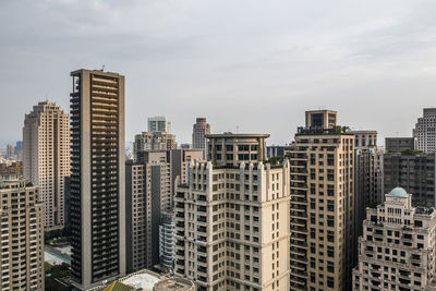 Modern buildings in city against sky