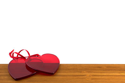 Close-up of heart shape on table against white background