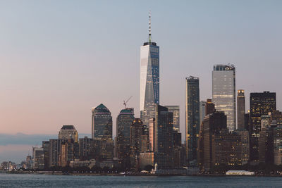 Skyscrapers against sky during sunset