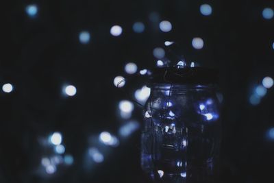 Close-up of glass jar against defocused black background