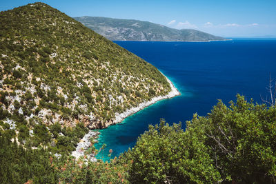 High angle view of sea and mountains against sky