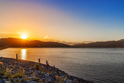 Scenic view of lake against sky during sunset