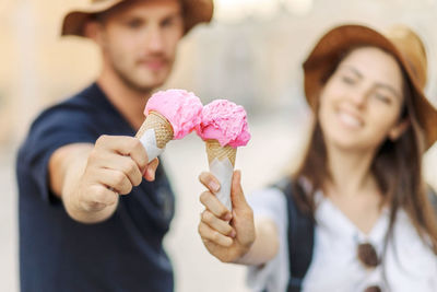 Happy couple eating ice cream in rome, italy. beautiful bright ice cream  in the hands