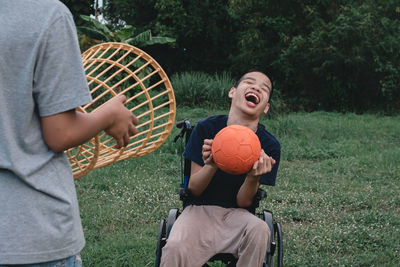 Boy playing with ball on grass