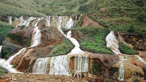 View of waterfall on rock formations