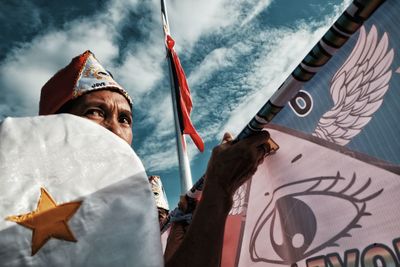 Low angle view of person against sky