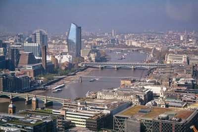 High angle view of river amidst buildings in city against sky