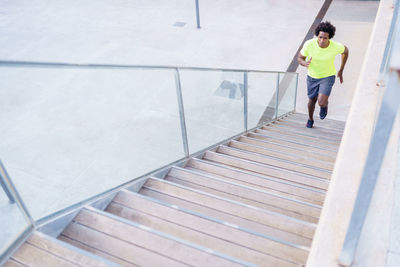 High angle view of man running on staircase