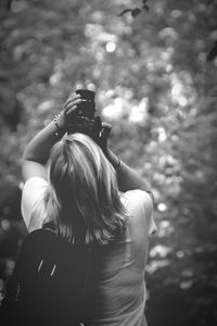 Rear view of woman photographing