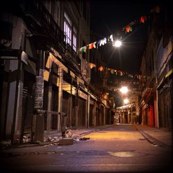 Illuminated street lights in city at night