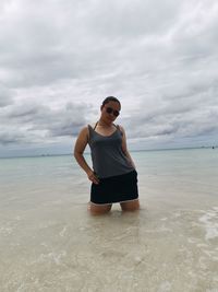 Full length of man standing on beach against sky