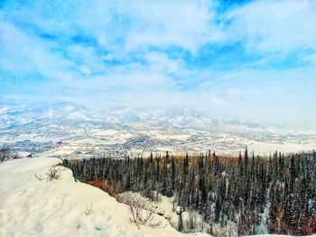 Snow covered landscape against sky