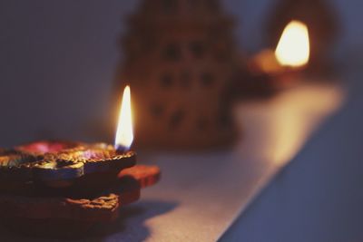 Close-up of lit candle in dark room