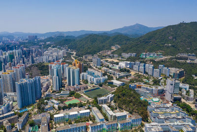 High angle view of buildings in city against clear sky