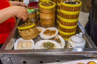 Cropped image of person preparing food for sale at market stall