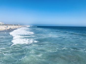 Scenic view of sea against clear blue sky