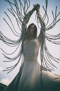 Low angle view of woman against sky