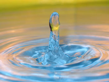 Close-up of drop falling on water surface