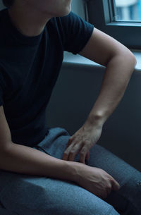 Low section of man sitting at home