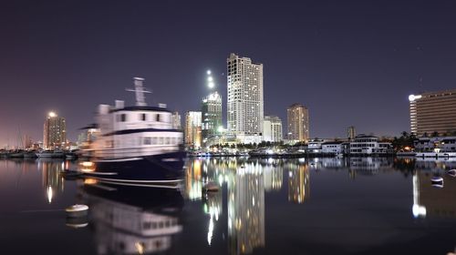 Illuminated city at waterfront