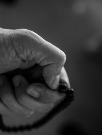 View of person holding prayer beads