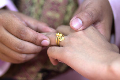 Couple exchanging rings during wedding ceremony