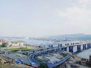 High angle view of bridge over cityscape against sky