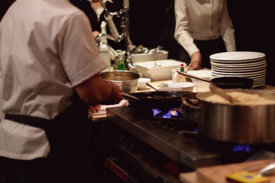 Midsection of chef preparing food in kitchen