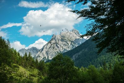 Scenic view of mountains and valley against cloudy sky