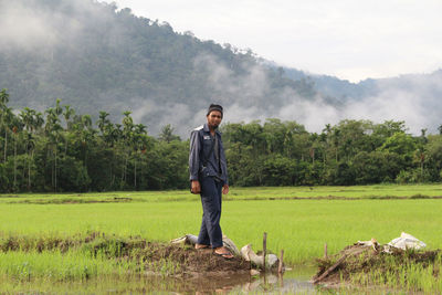 Young man standing on field