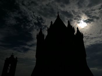 Low angle view of silhouette temple against sky