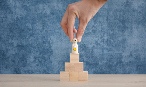 Midsection of child playing with toy on wood