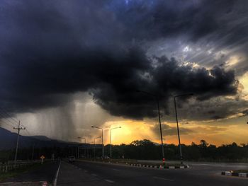 Road against cloudy sky at sunset