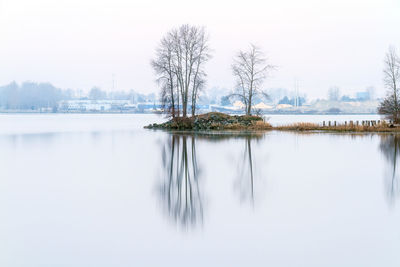 Scenic view of lake against sky during winter