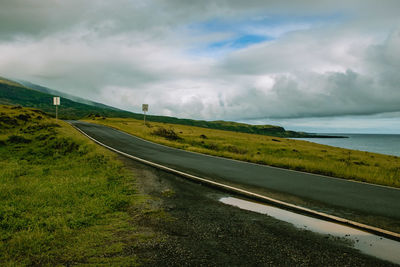 Empty road along countryside landscape