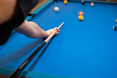 Cropped hand playing pool