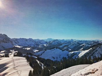 Scenic view of snowcapped mountains against clear sky