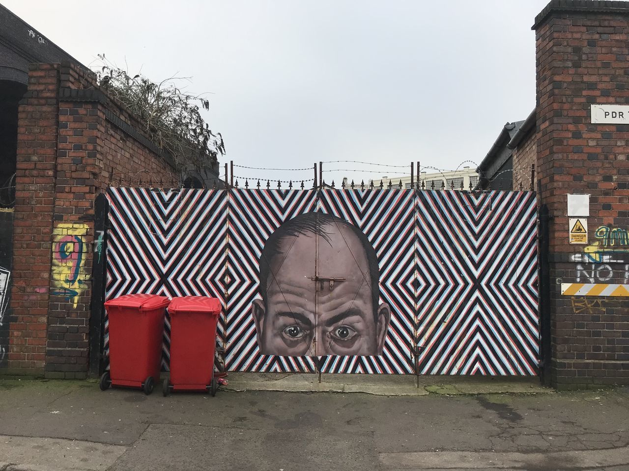 PORTRAIT OF MAN AGAINST BRICK WALL