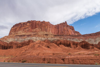 Capitol reef national park low angle landscape of pink, orange and purple barren stone hillside 