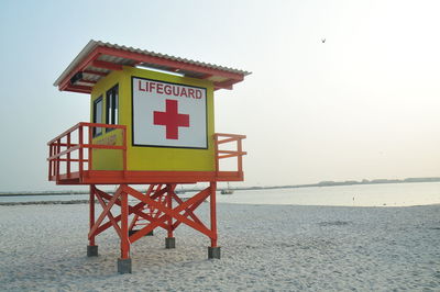 Lifeguard hut on beach against clear sky