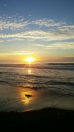 Scenic view of beach against sky during sunset