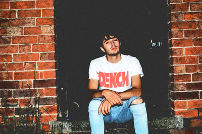 Man sitting against wall