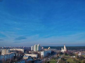 High angle view of buildings against blue sky