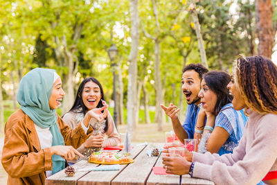 Friends having food at park