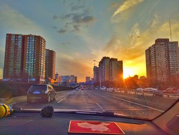 Traffic on city street during sunset